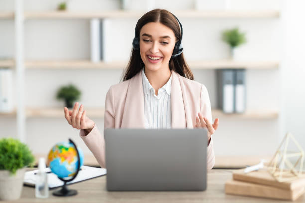 istock Cheerful Female Talking Via Video Call On Laptop In Office 1329037146