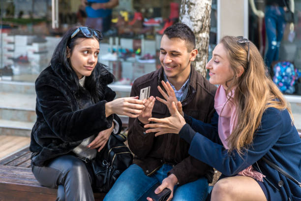 istock Two women and a man shopping 1329038370