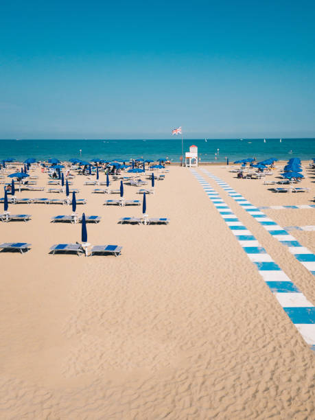 istock Italian holiday resort sand beach with a Great Britain flag 1329038405
