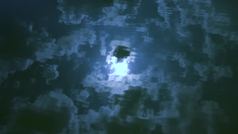 Moon and Clouds Reflecting Off Water Surface