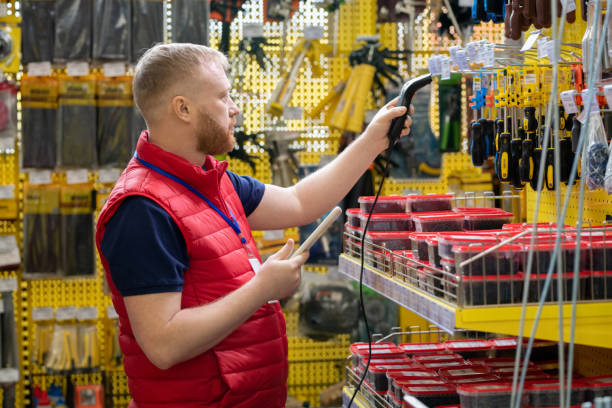 istock Young man with tablet and scanner checking prices of goods 1329039324