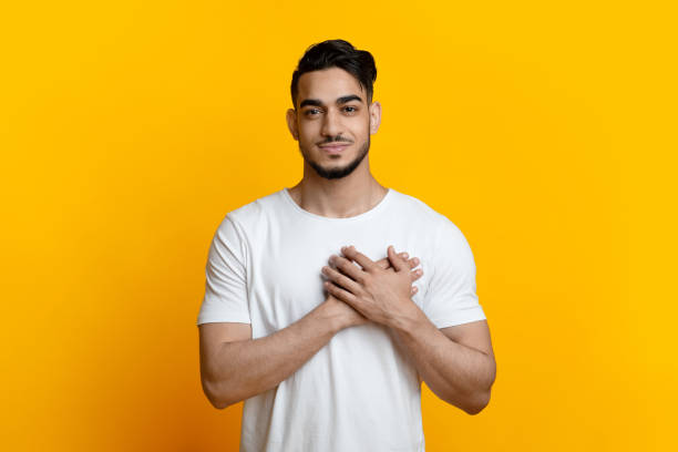 istock Smiling arab guy holding palms on chest 1329040061