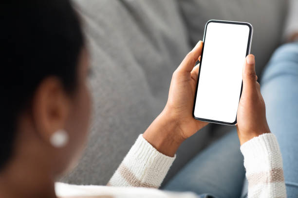 istock Unrecognizable Black Woman Holding Blank Smartphone With White Screen At Home 1329040075