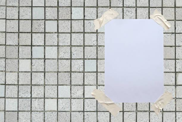 istock Blank white paper attached to the wall with tape. 1329041073