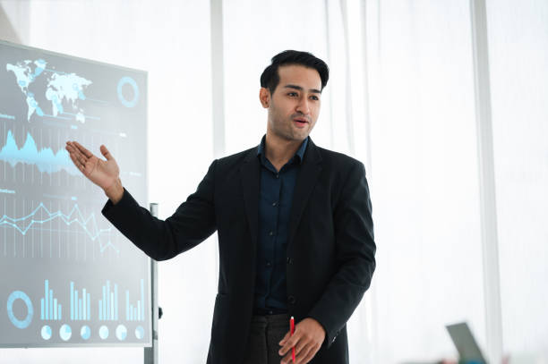 istock Businessman or manager presents a discussion graph, a strategic planning report, and discusses ways to increase profits with colleagues at the workshop. Brainstorming and teamwork concept. 1329041082