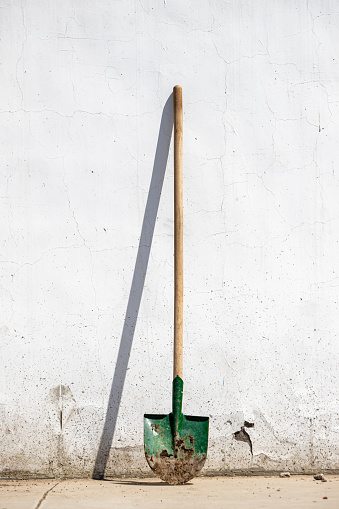 Old rusty metal and wood dirt shovel