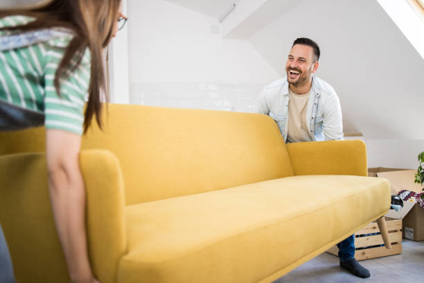 istock Young couple bringing the new sofa into their new home 1329042255
