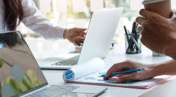 istock Business People Talking Discussing with coworker planning analyzing financial document data charts and graphs in Meeting and successful teamwork Concept. 1329043137