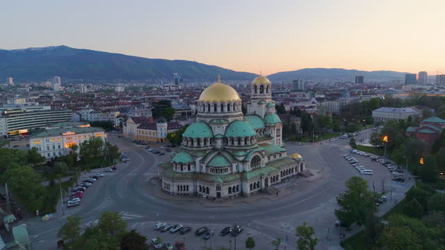 Wide drone shot of St. Alexander Nevski Cathedral in Sofia, Bulgaria at sunset,(Bulgarian: Катедрала Свети Александър Невски, София, България), forward, dolly shot