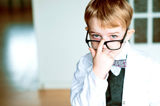 istock Cute child with lab coat adjusts his glasses 1329044206