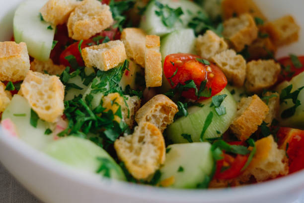 istock Homemade salad with bread, tomatoes, cucumber, basil and sauce 1329045731