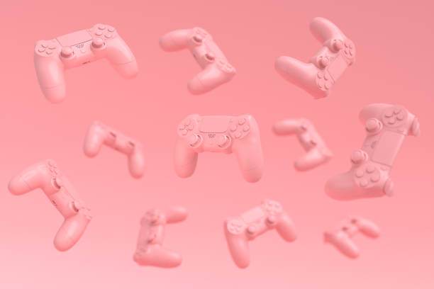 istock Flying gamer joysticks or gamepads on pink background with blur 1329045795
