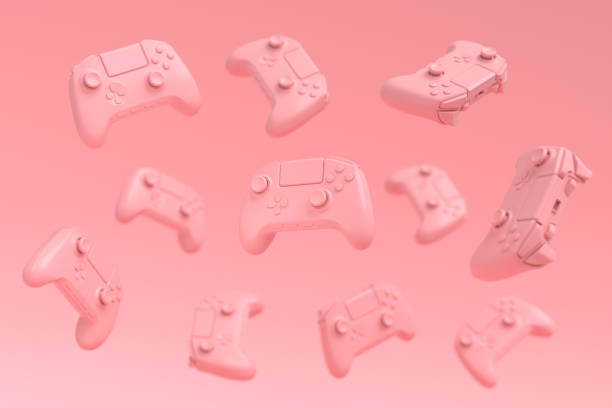 istock Flying gamer joysticks or gamepads on pink background with blur 1329045817