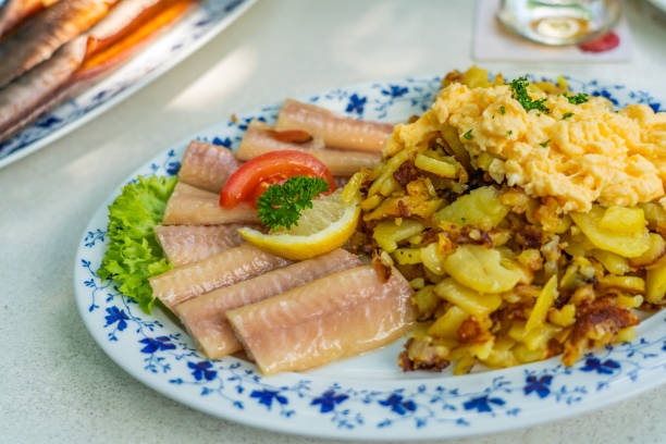 Smoked Eel - Fish filet on a plate with fried potatoes