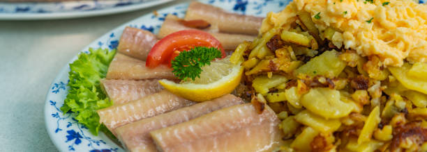 istock Smoked Eel - Fish filet on a plate with fried potatoes 1329046645