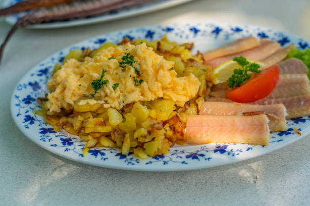 istock Smoked Eel - Fish filet on a plate with fried potatoes 1329046648