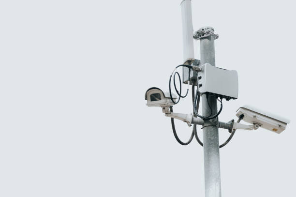 istock CCTV camera electric pole on isolated white sky with copy space. Safe and secure technology outside property and homeowner concept. Security card device and gadget theme. Outdoor electronic 1329047994