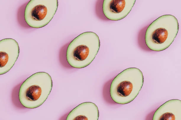 istock top view of cut avocado on pink background 1329048271