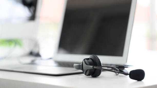 istock Headsets for call center teams are placed at a desk with a computer and laptop. while the team is in the break 1329048346