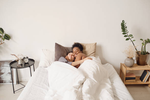 istock African woman embracing her sleeping girlfriend 1329048869