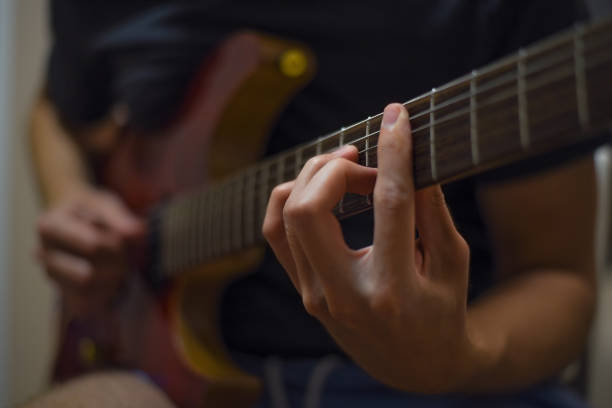 istock Man playing electric guitar. 1329048912