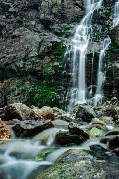 istock waterfall white water stream falling from mountains at day from low angle 1329050771