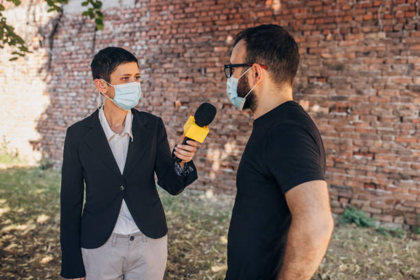 istock Female TV reporter interviewing a man 1329052639