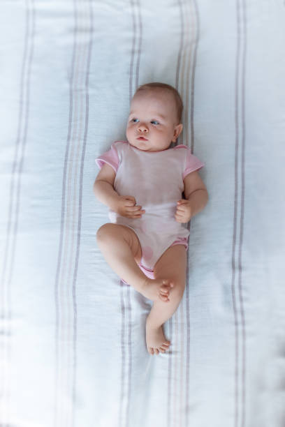 istock Little baby gerl leaning on the bed. 1329052675