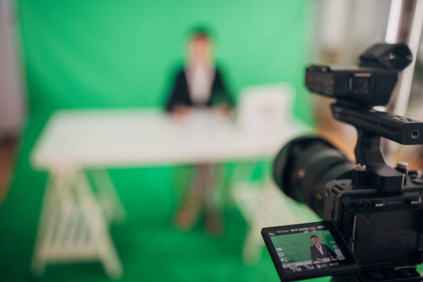 istock Woman anchor reading news in studio 1329052682