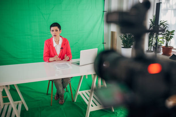 istock Woman anchor reporting news in studio 1329052701