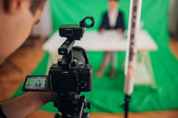 istock Woman anchor reading news in studio 1329052839