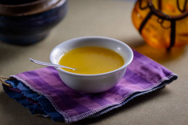 istock Ghee butter from India in white dinnerware container on wooden table. 1329052887