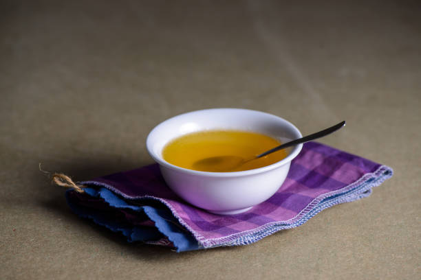 istock Ghee butter from India in white dinnerware container on wooden table. 1329052944
