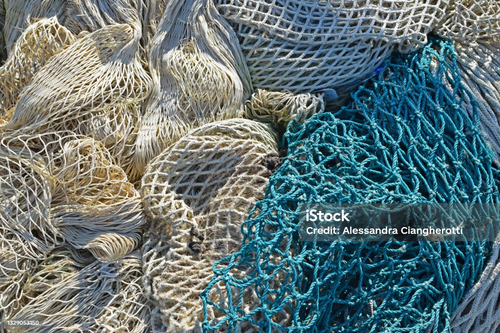 Fishing nets drying in the sun Blue and white fishing nets. Commercial Fishing Net Stock Photo