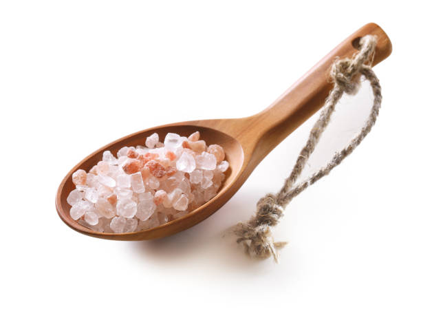 sal rosado del himalaya cristalino en una cuchara de madera aislada sobre fondo blanco. - salt crystal spoon food fotografías e imágenes de stock