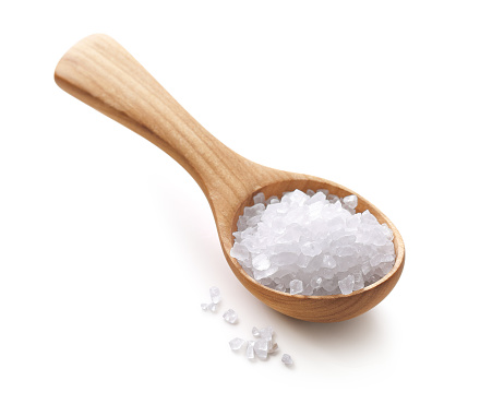 Close-up wooden spoon with salt.