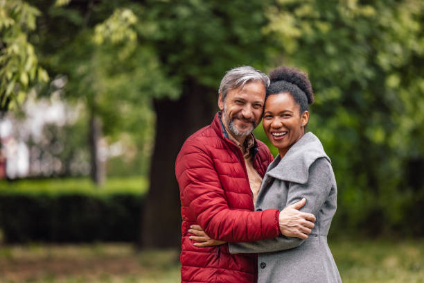 istock Adult couple, looking in the camera, while smiling. 1329055783