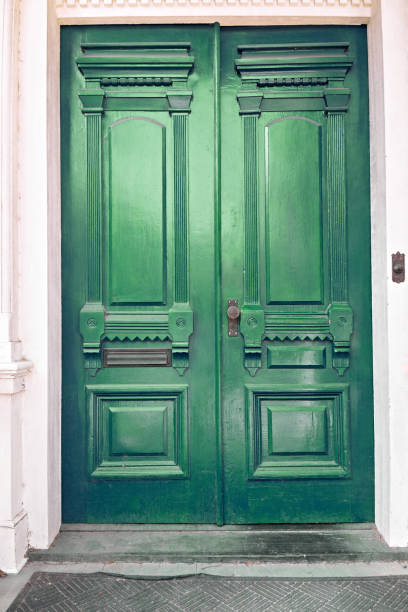 istock Double antique front doors painted in a glossy grass green paint 1329056930