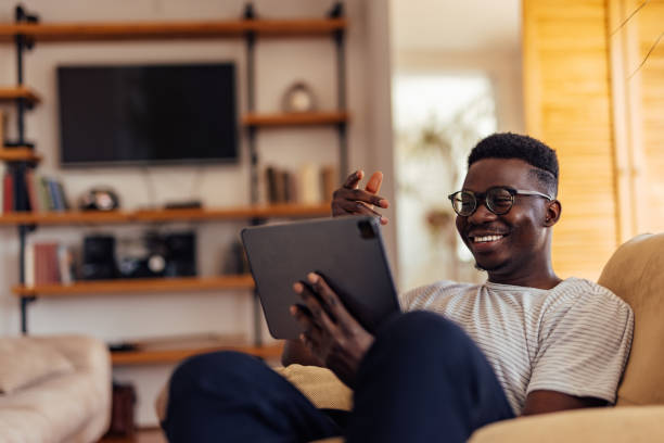 istock Adult man, finding his favorite book online. 1329057160