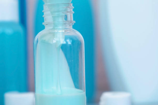 Pouring a blue liquid in a bottle
