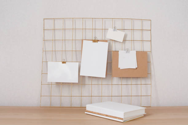 istock Blank white poster, cards mock up attached on gold grid board. 1329061626