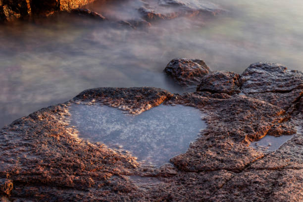 Natural heart shaped puddle on the beautiful rocky seashore, Åland islands, Finland Natural heart shaped puddle on the beautiful rocky seashore, Åland islands, Finland åland islands stock pictures, royalty-free photos & images