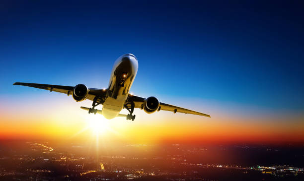 istock Plane goes on takeoff at sunset over the city lights 1329063476