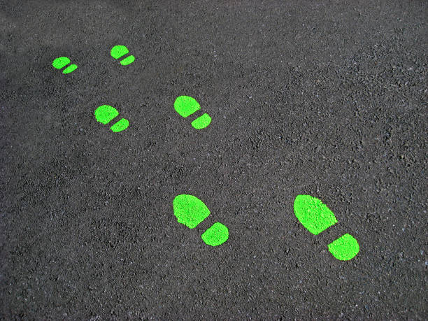 Green footprints on cement stock photo