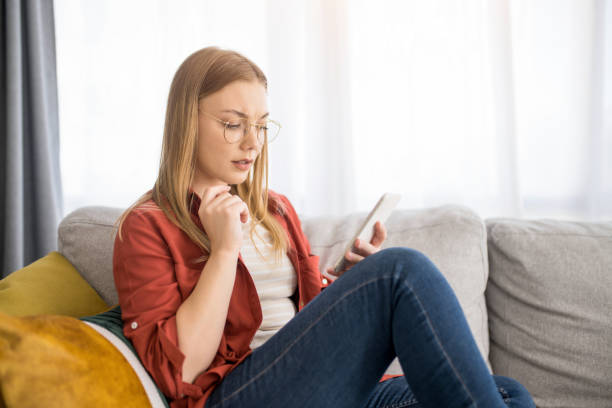 istock Young woman using phone at home. 1329065426