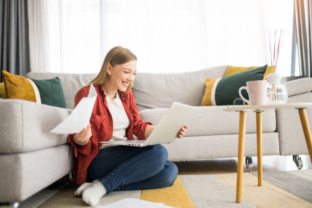 istock Cheerful young woman working at home. 1329065610