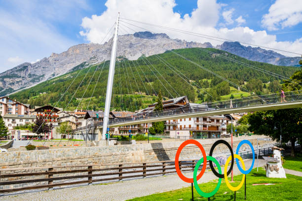 Bormio & the Olympic Games (Lombardy, Italy) The five-ringed symbol of the Olympic Games placed on the bank of the river Adda in Bormio remembers that the city will be one of the locations of the 2026 Winter Olympics, officially known as the XXV Olympic Winter Games. olympic city stock pictures, royalty-free photos & images