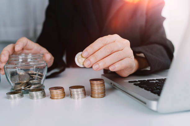 istock Male hand putting coins with money stack step growing growth and dollar bag. saving money, Concept finance business investment. 1329068061