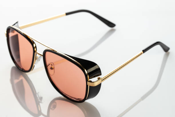 istock Sunglasses on a white reflective surface. Fashionable, stylish accessories. Use it for a vacation or summer concept. 1329068262