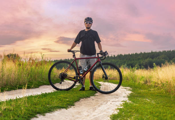 istock Cyclist standing with his gravel bicycle during outdoors sport training 1329071629